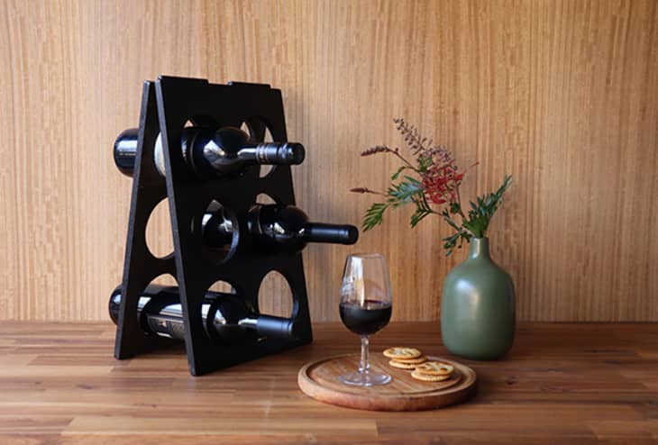 Black A-frame wine rack on wood countertop