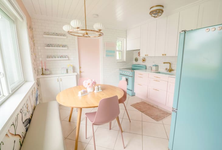 pink, blue and white kitchen with light coming in from a large window