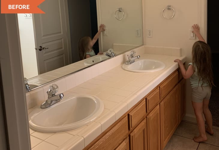 Before: bathroom with orangey wood vanity and white walls