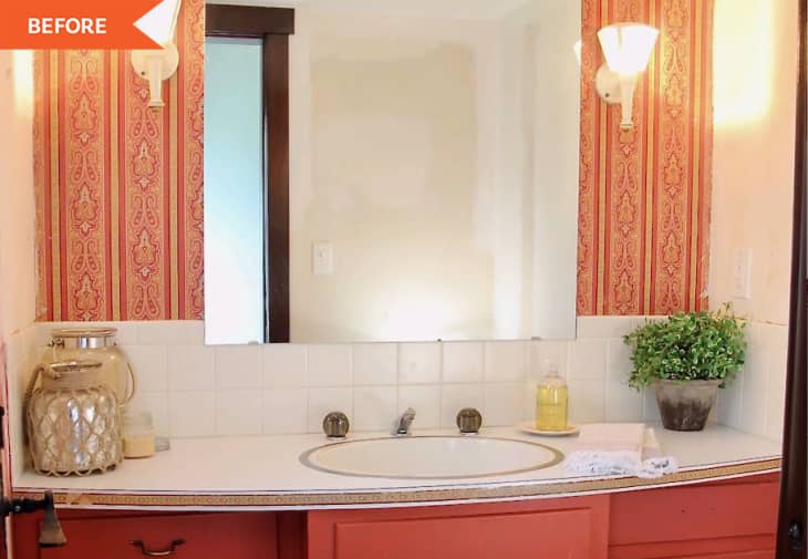 Before: Bathroom vanity with red wallpaper behind mirror