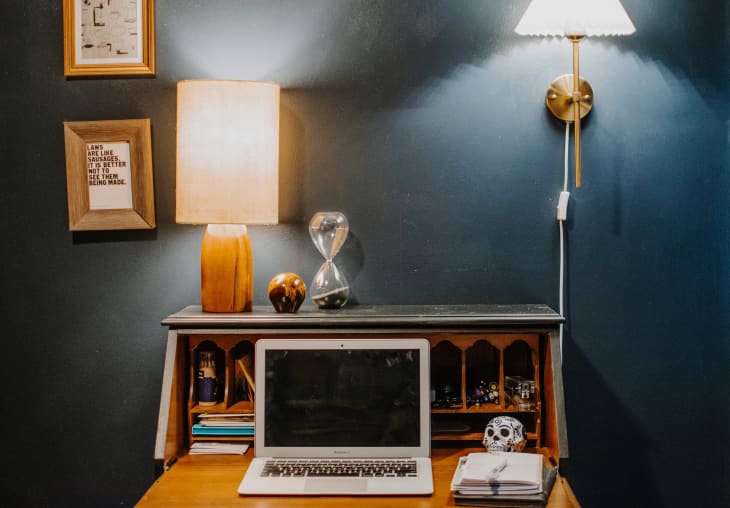 home workspace with deep blue walls, wood desk