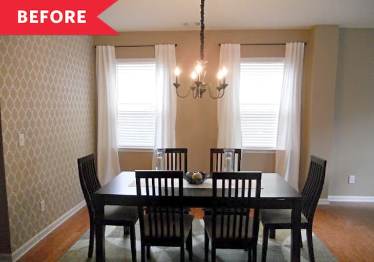 Dining room with dark wood table and chairs, chandelier, patterned accent wall, and two windows with white curtains.