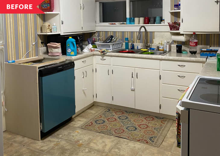 Before: Kitchen with white cabinets, beige tile floor, and striped blue and yellow wallpaper