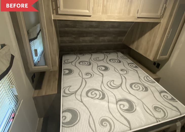 Before: Camper bedroom with gray toned wood cabinets