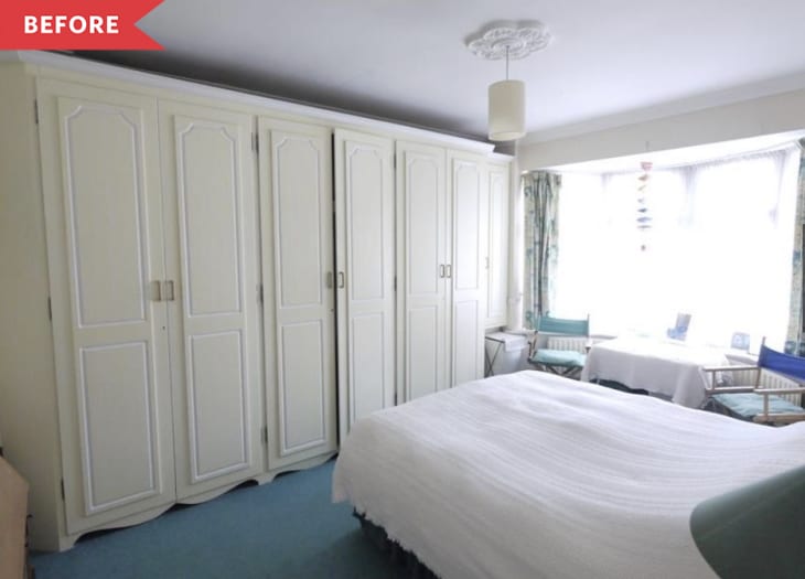 Before: green-carpeted bedroom with built-in cabinetry