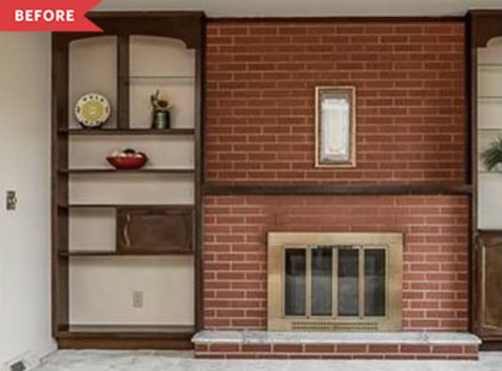 Before: red brick fireplace with wood shelving on the sides and a brass fireplace insert
