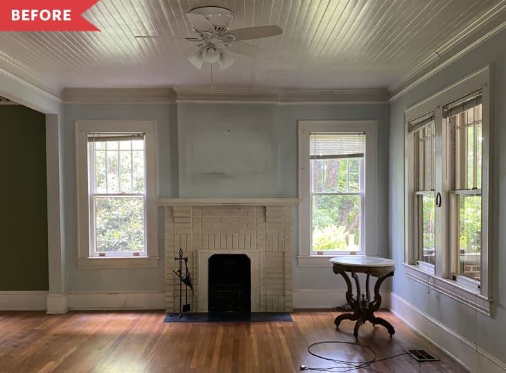 Before: Empty living room with old brick fireplace and dirt and dust-covered walls