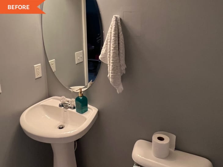 Before: gray bathroom with white sink and oval mirror