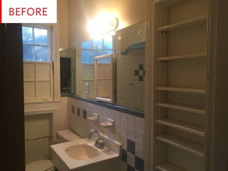 Small bathroom with white sink, mirror, tiled walls, window, and empty shelves.
