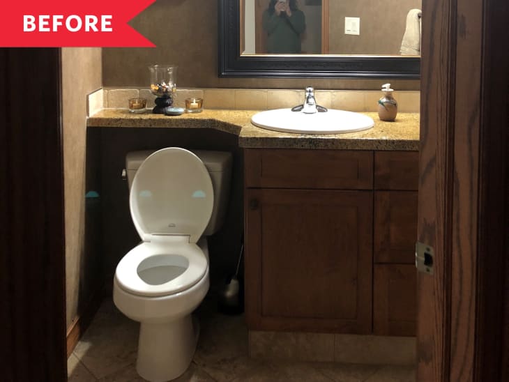 Small bathroom with wooden vanity, round sink, and toilet. Brown walls and mirror above the sink.