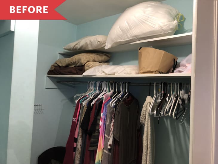 Cluttered closet with clothes on hangers, shelves with pillows, and a paper bag.