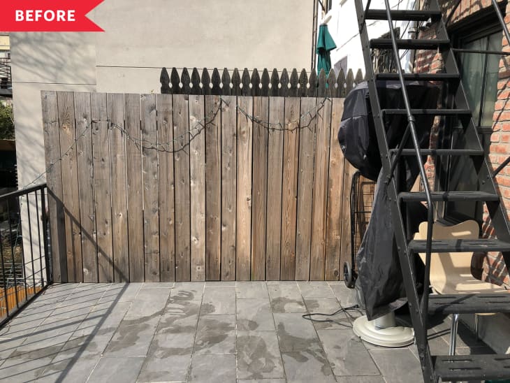 Before: Empty patio with brown wood fence