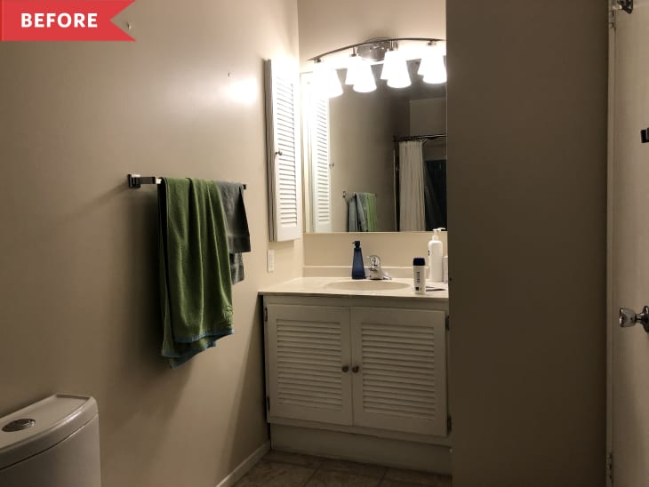 Before: Dimly lit bathroom with green towel hanging on rod