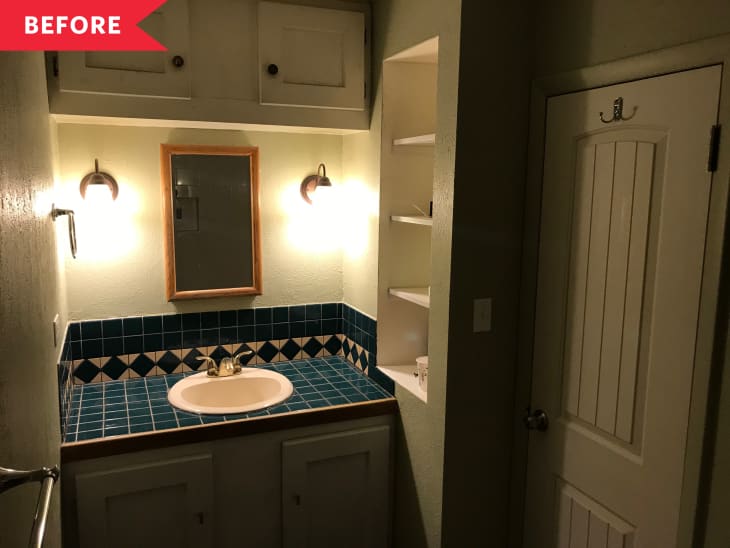 Before: Dark green-painted bathroom with tiled vanity