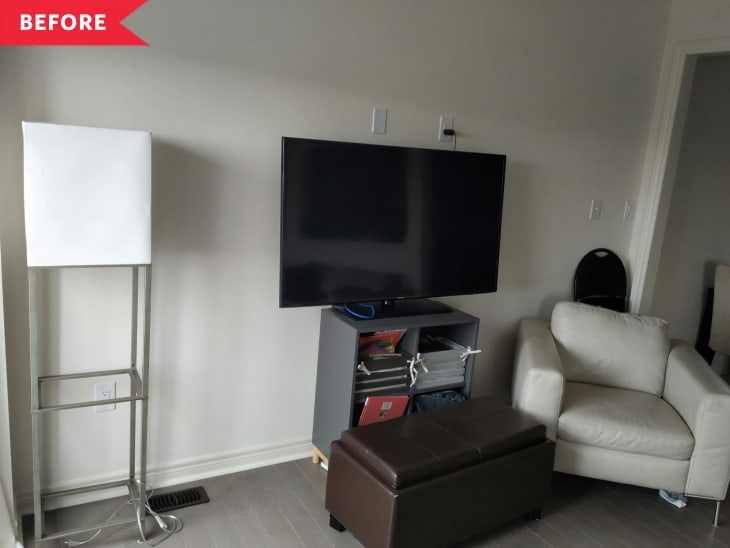 Before: TV on small gray shelf in living room next to off-white leather armchair and brown ottoman