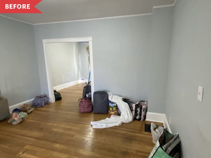 Before: Living room with soft blue walls mostly empty except for bags around the perimeter