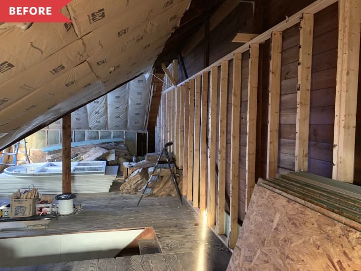 Before: Unfinished attic with large window and drywall boards on floor