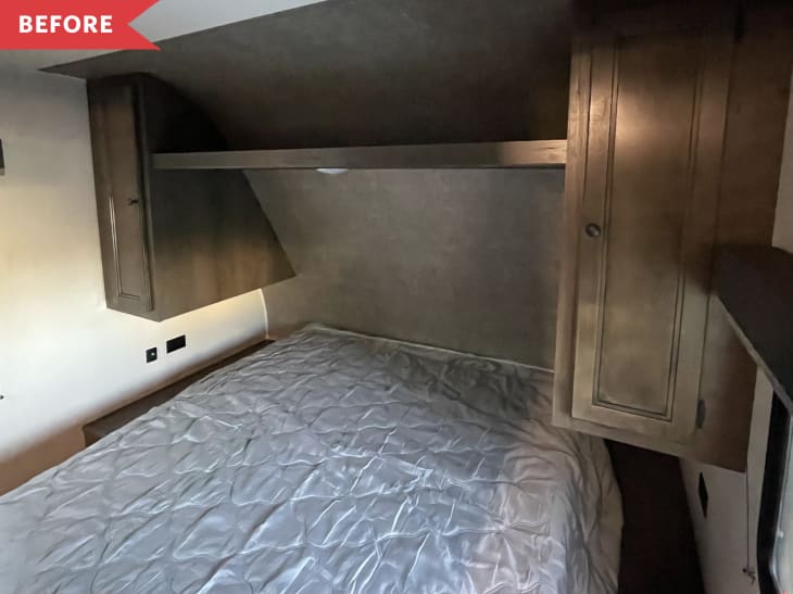 Before: Old mattress in brown, dated sleeping area in RV