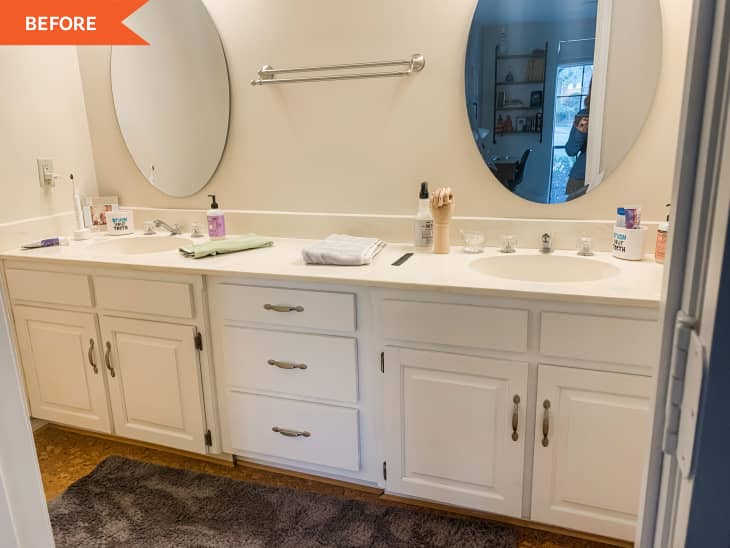 Double sink with oval mirrors and white cabinets