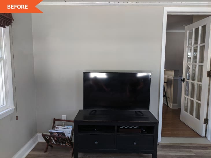 Before: Blank gray wall with a tv on a black TV stand sitting in front of it