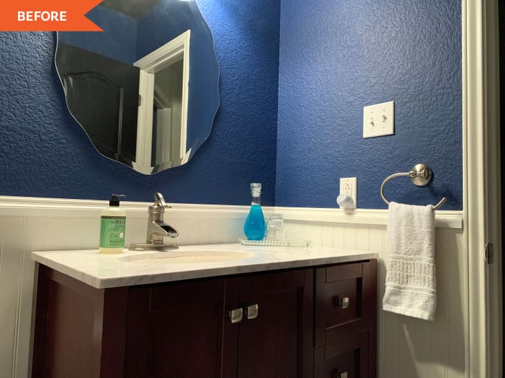 Before: Blue bathroom with brown vanity