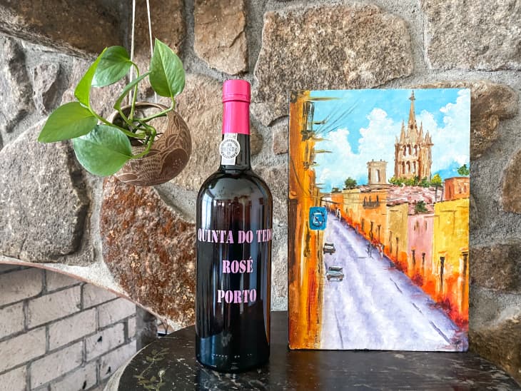Bottle of port beside a painting.