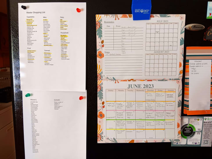 shopping list, calendar, reminders posted on fridge