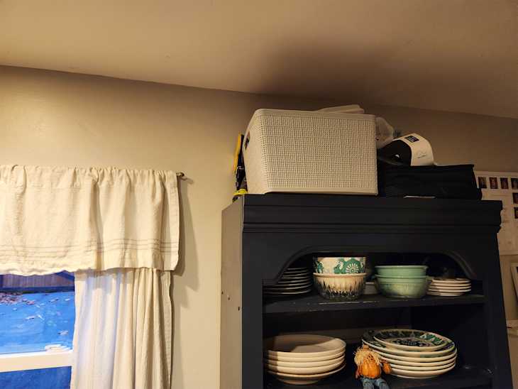 Bin on top of kitchen storage unit.