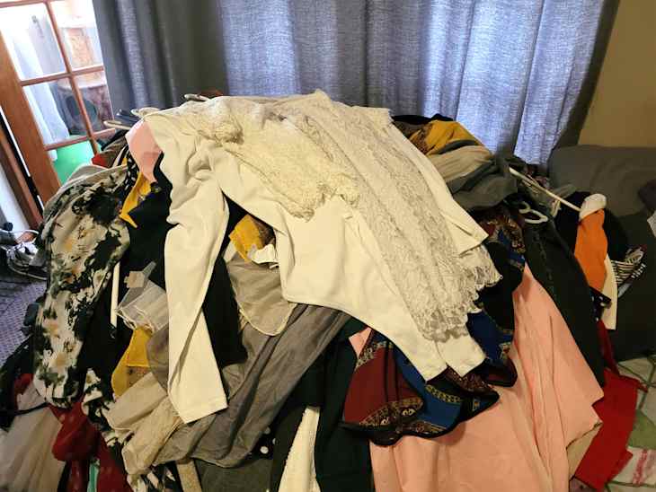 Clothes on bed during digital clean out.