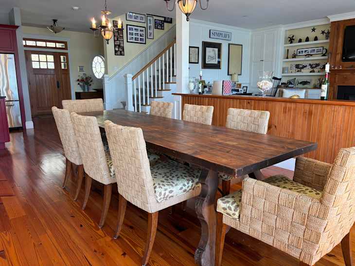 Vintage wooden dining table surrounded by chairs.