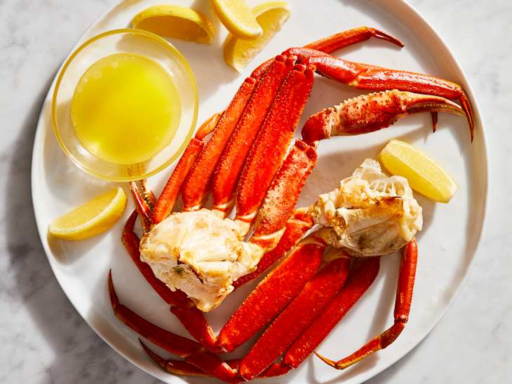 Cooked crab legs served on a platter.