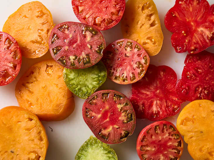 overhead shot of sliced heirloom tomatoes on a cutting board