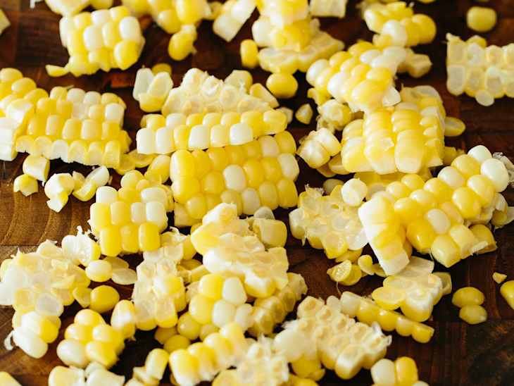 yellow corn kernels on wooden surface
