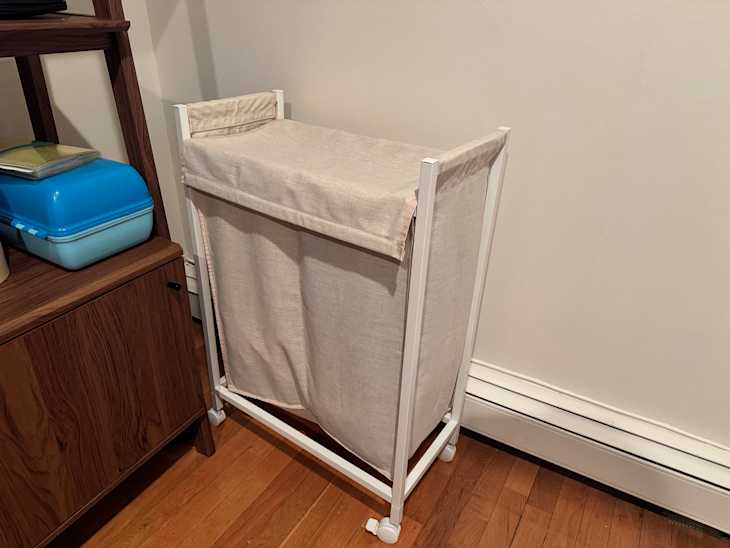 ENHET Laundry bin with casters in someone's home