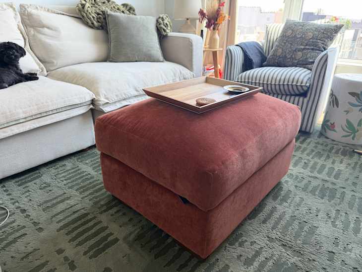 Tray on top of pink Joybird ottoman in living room.