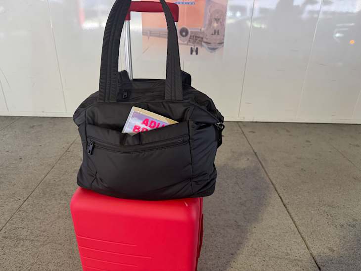 Quince expandable tote on top of suitcase.