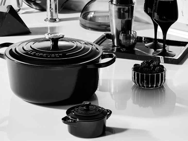 b+w photo of le creuset cookware on table