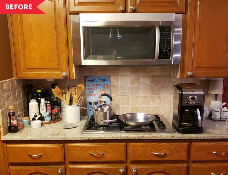 Before: Dated brown cabintry with silver pulls around microwave and stovetop