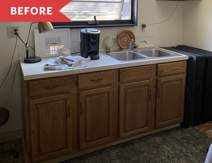 kitchenette before renovation wood cabinets gold lamp white walls