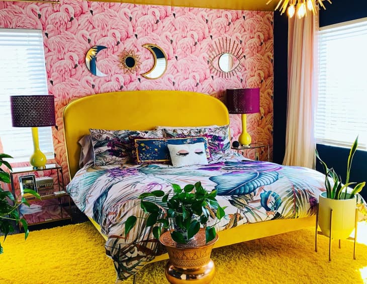 Bedroom with flamingo wallpaper and yellow bed