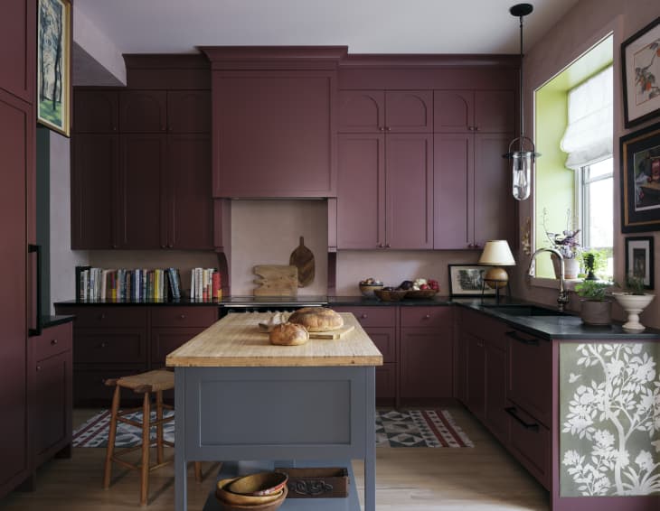 Kitchen of Sophie Donelson with cranberry cabinetry and a blue-grey island