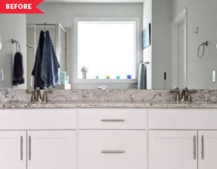 Before: Bathroom with sheet mirror, white cabinets, and gray stone countertops