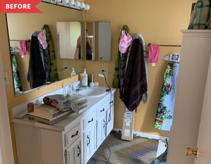 Before: Bathroom with gold walls, sheet mirror, and Hollywood bulbs