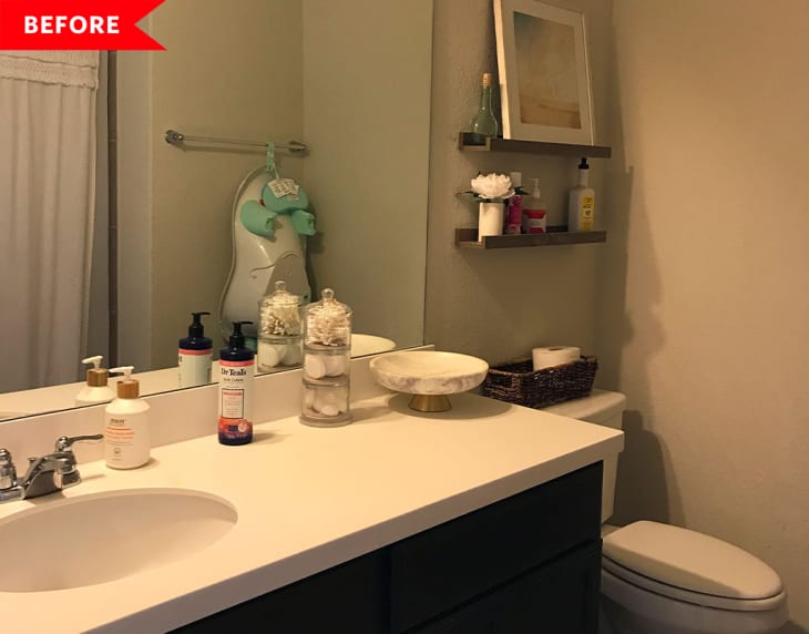 Bathroom with white countertop, sink, toiletries, wall shelves, and a wicker basket on the toilet.