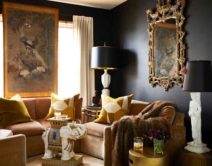 Lounge area with black walls and gold/warm accents