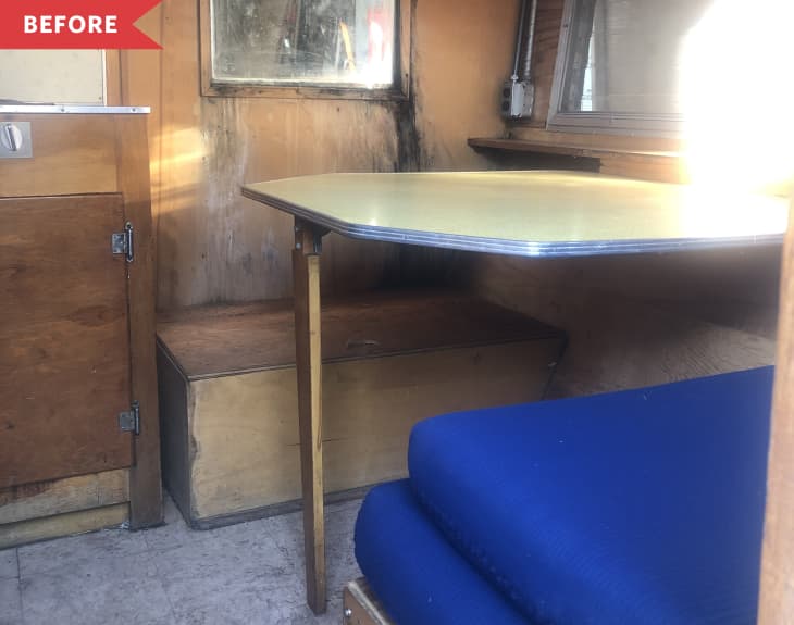 Before: Dated camper with worn wood interior