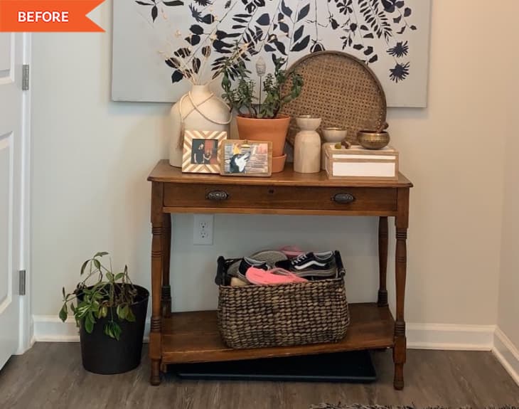 Before: Entryway with beige walls, large artwork, and wooden console table