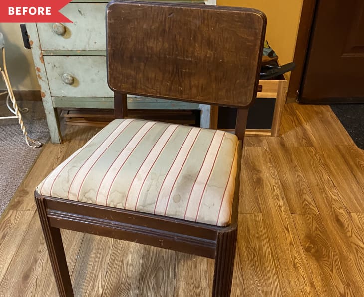 Wooden chair with striped cushion on wooden floor, next to a vintage green dresser.