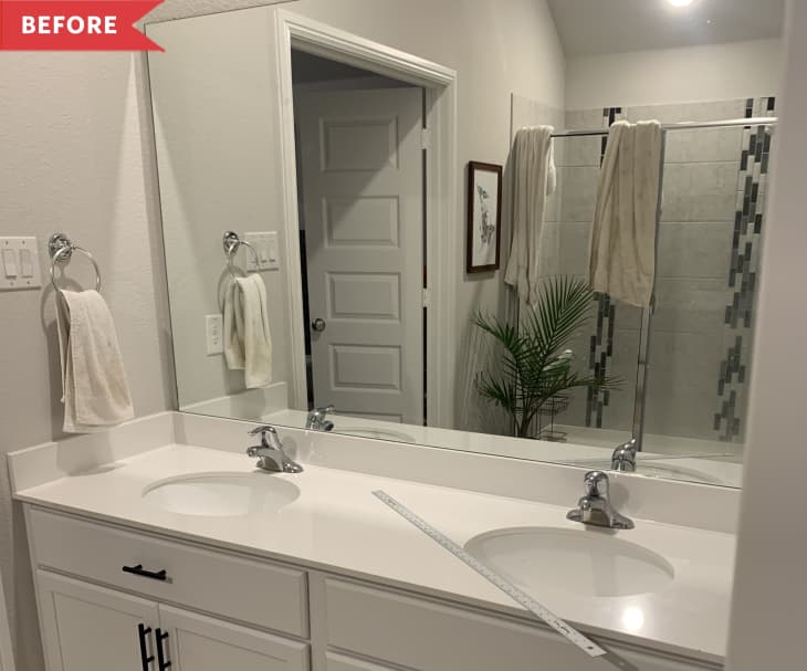 Before: Basic bathroom with gray walls and sheet mirror above white vanity