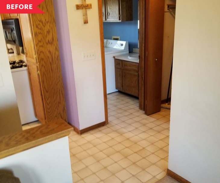 Before: dark wood and beige entryway looking into laundry/bathroom